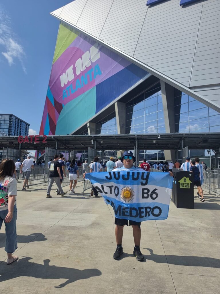 Hernán Cruz con la bandera del B6 frente al estadio de Atlanta